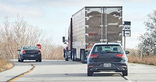 Semi truck with car tailgating
