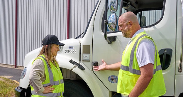 Driver and Manager talking by side cam mounted on side of box truck