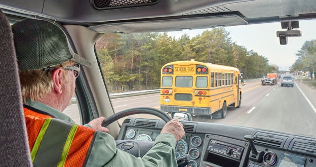 Driver with dash cam on busy road