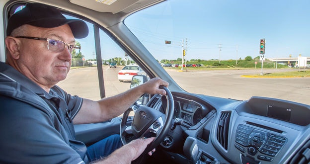 Person driving a van looking as going through intersection