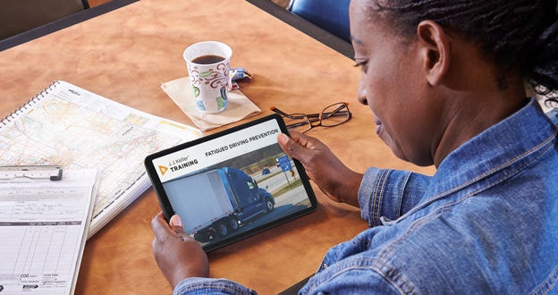 Driver viewing Corrective Action Training video on tablet