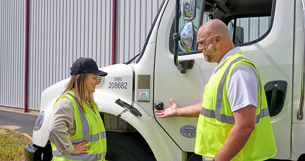 Driver and Manager talking by side cam mounted on side of box truck