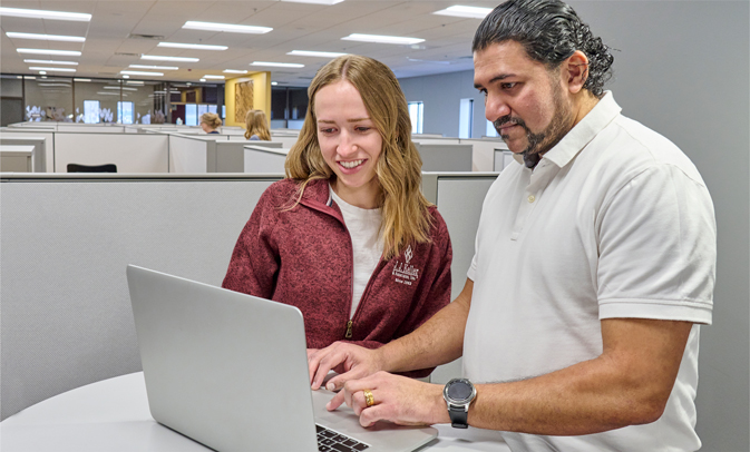 two people with laptop